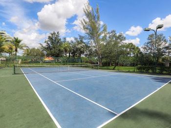 A blue tennis court with a net on it